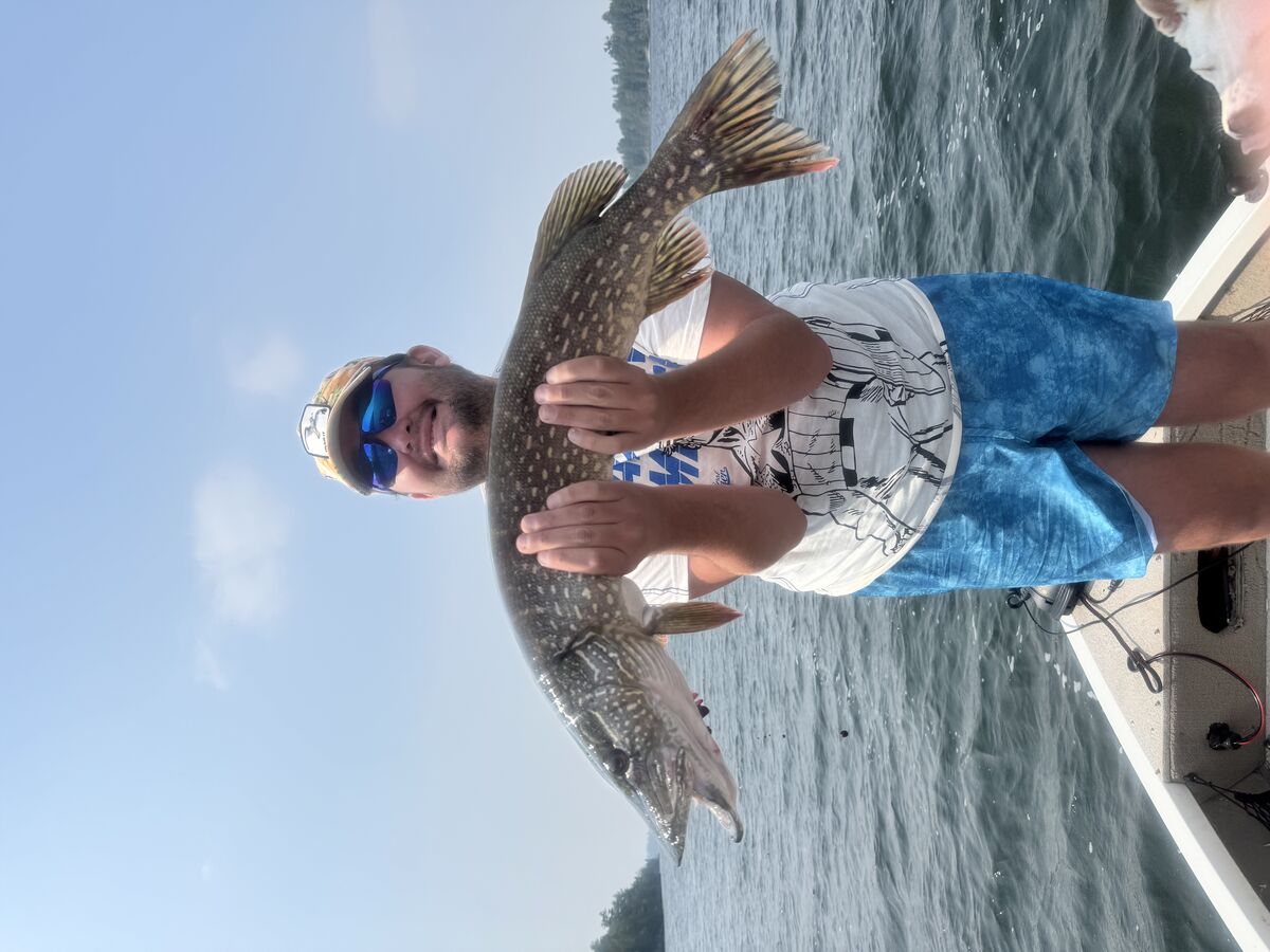 Holding a nice pike for the photo before it was released.